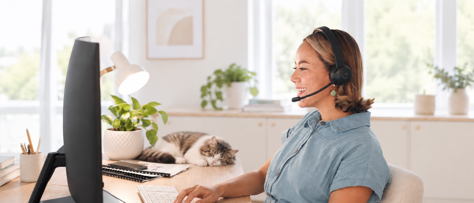 Smiling Woman Wearing Headset Working at Computer